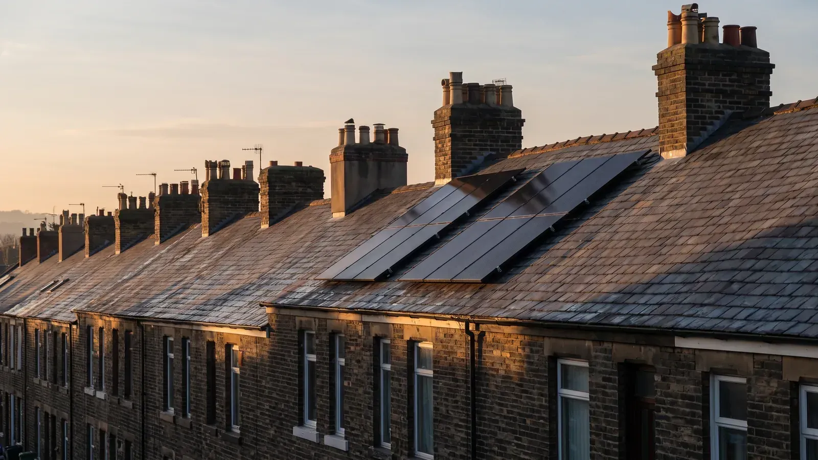 Solar panels fitted on the slate roof of a terraced house in the UK